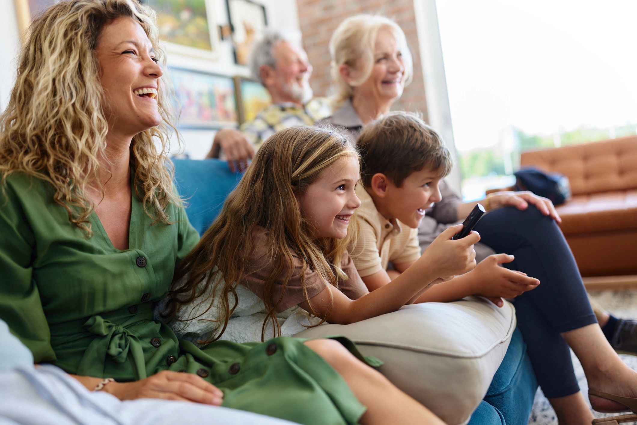 Family watching TV together at home